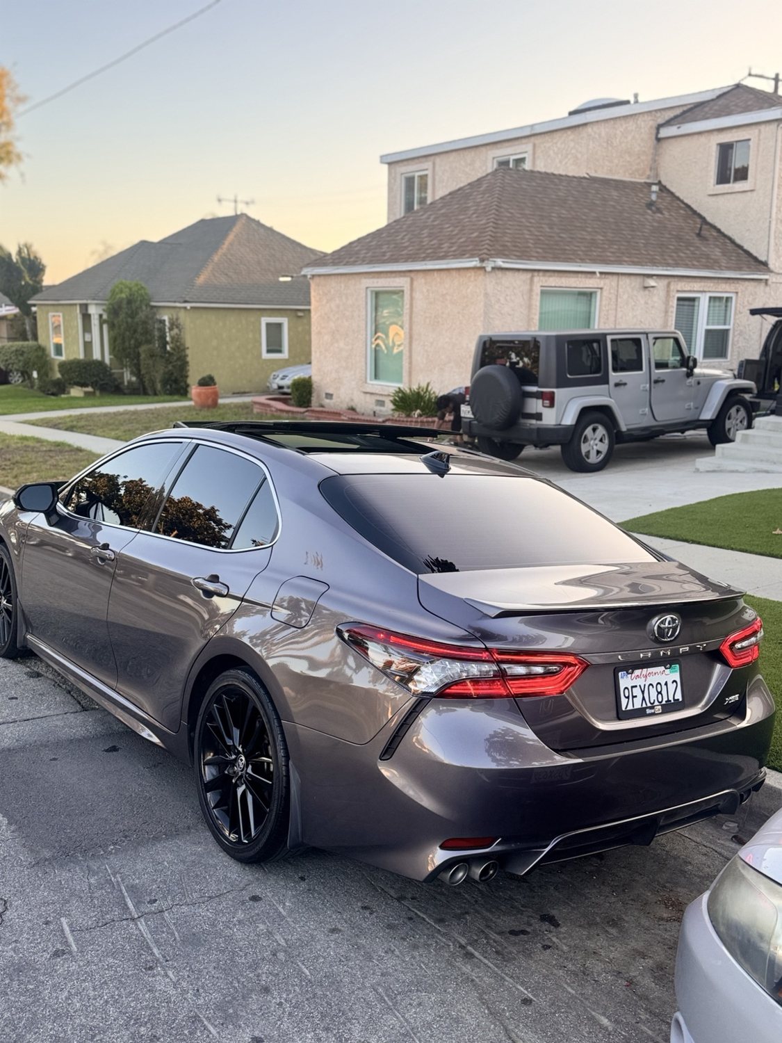 Gray Toyota Camry with a reflective exterior finish